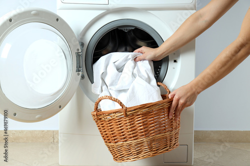 Concept of housework with washing machine against white wall