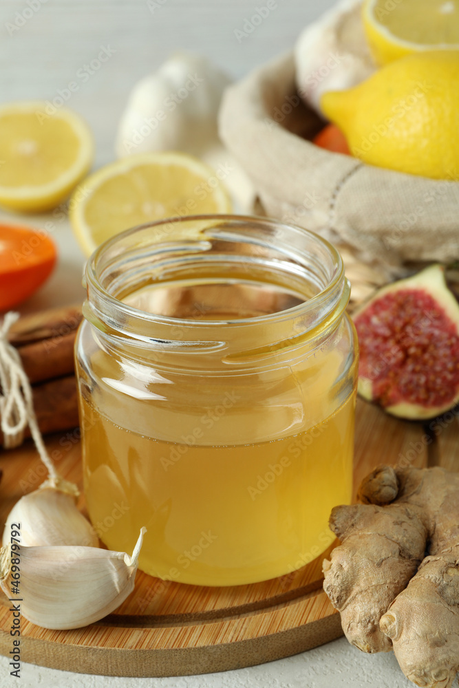 Concept of treatment colds with honey and garlic, close up Concept of treatment colds with honey and garlic, close up