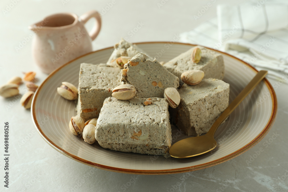 Concept of tasty food with halva on light background Concept of tasty food with halva on light background