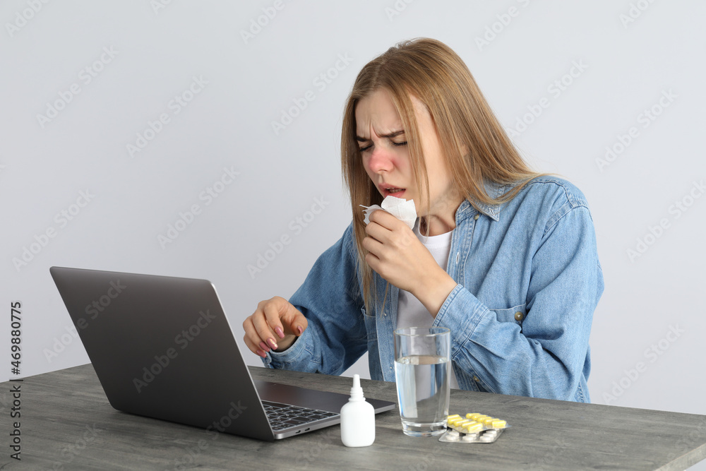 Ill young woman sitting on workplace, seasonal cold concept Ill young woman sitting on workplace, seasonal cold concept