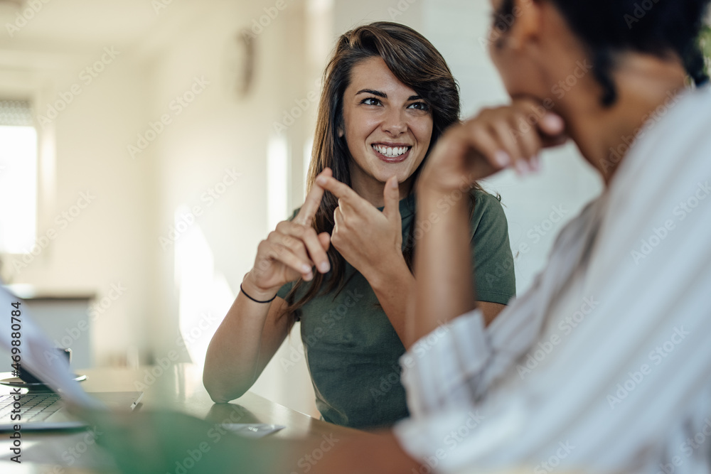 Two diverse coworkers, exchanging their stories Two diverse coworkers, exchanging their stories