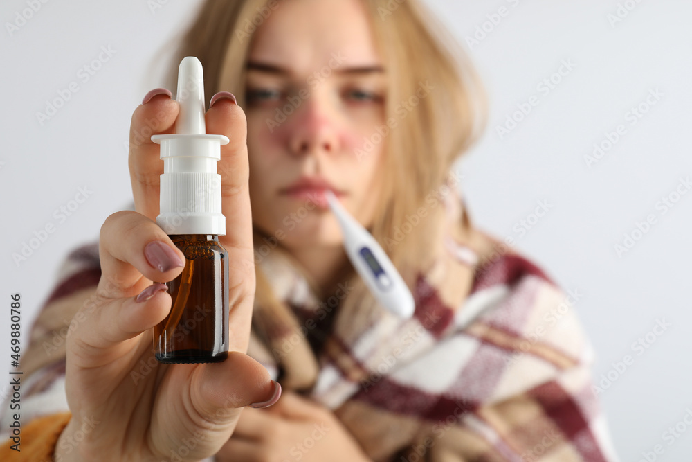 Ill young woman on light background, seasonal cold concept Ill young woman on light background, seasonal cold concept