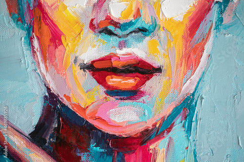 Oil portrait painting in multicolored tones. Abstract picture of a beautiful girl. Conceptual closeup of an oil painting and palette knife on canvas.