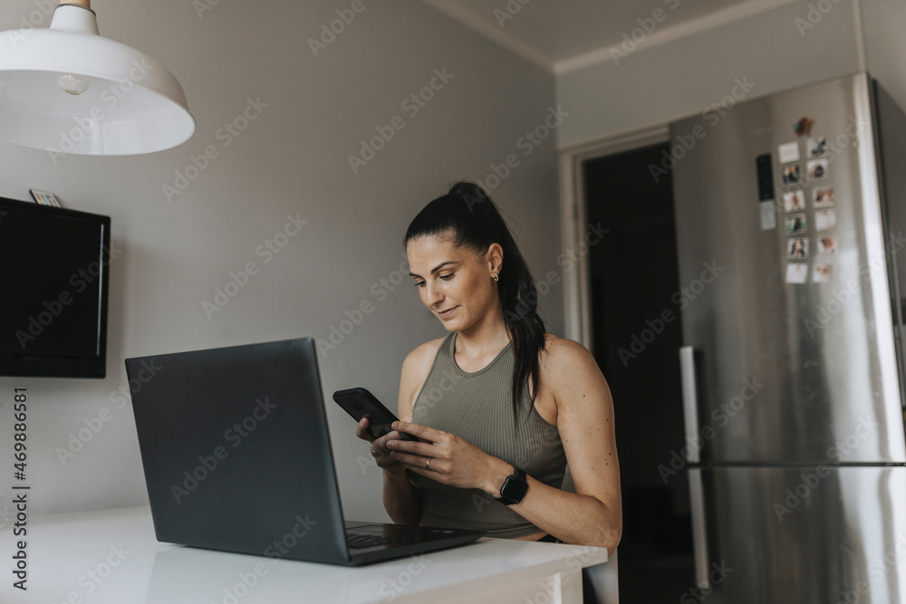 Smiling woman using laptop