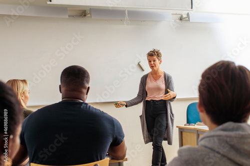 Teacher giving lecture in classroom photo