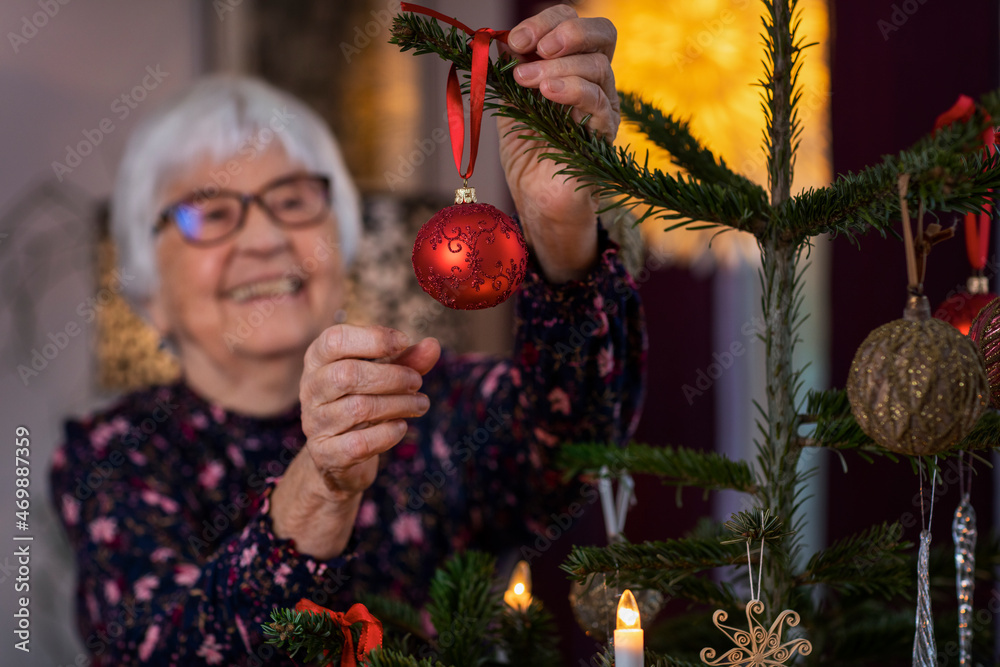 © Johnér - Woman decorating Christmas tree