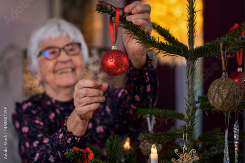 Woman decorating Christmas tree photo