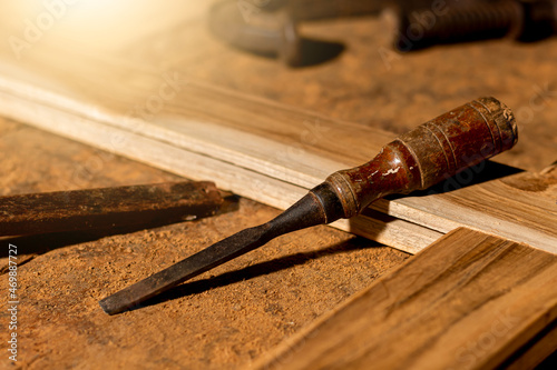 Close-up of a carpenter using a circular saw or a tool to cut wooden planks To make furniture in homes and residences, hotels, rooms made of wood.