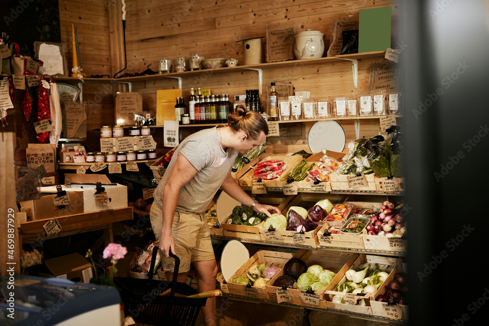 © Johnér - Man doing shopping in shop with organic food