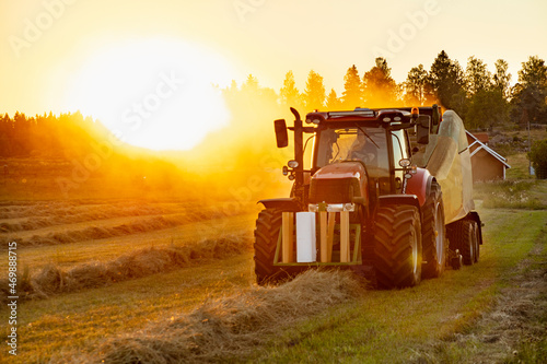 Tractor with baler on field