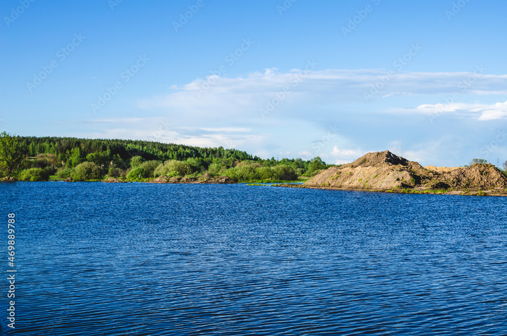 A flooded quarry where sand was mined for construction A flooded quarry where sand was mined for construction