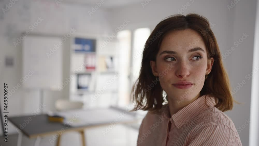 young woman sits in a bright modern office and looks thoughtfully to the side young woman sits in a bright modern office and looks thoughtfully to the side