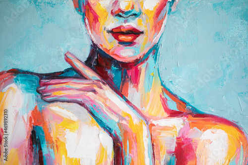 Fototapeta Naklejka Na Ścianę i Meble -  Oil portrait painting in multicolored tones. Abstract picture of a beautiful girl. Conceptual closeup of an oil painting and palette knife on canvas.