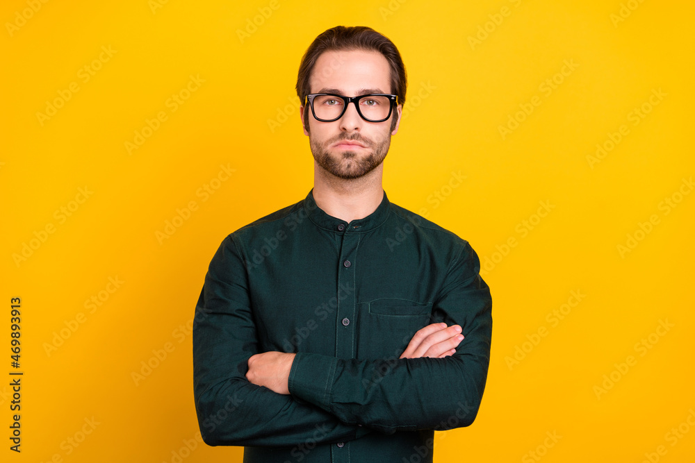 Photo of serious confident young guy dressed smart casual clothes spectacles arms crossed isolated yellow color background Photo of serious confident young guy dressed smart casual clothes spectacles arms crossed isolated yellow color background
