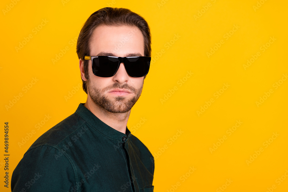 Fototapeta premium Photo of confident cool young guy dressed smart casual clothes dark eyewear empty space isolated yellow color background