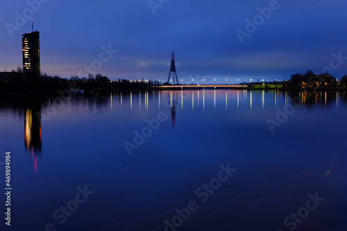Reflection of night lights at dawn on the Daugava in Riga against the background of the televised tower © IHAR