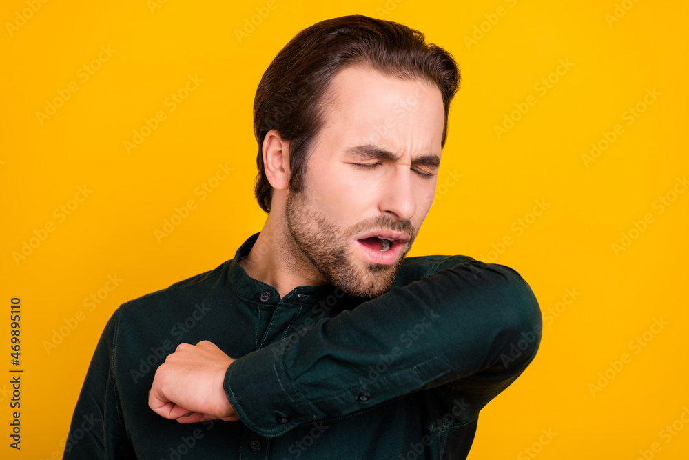 Obraz premium Photo of sad ill young guy dressed smart casual clothes sneezing isolated yellow color background