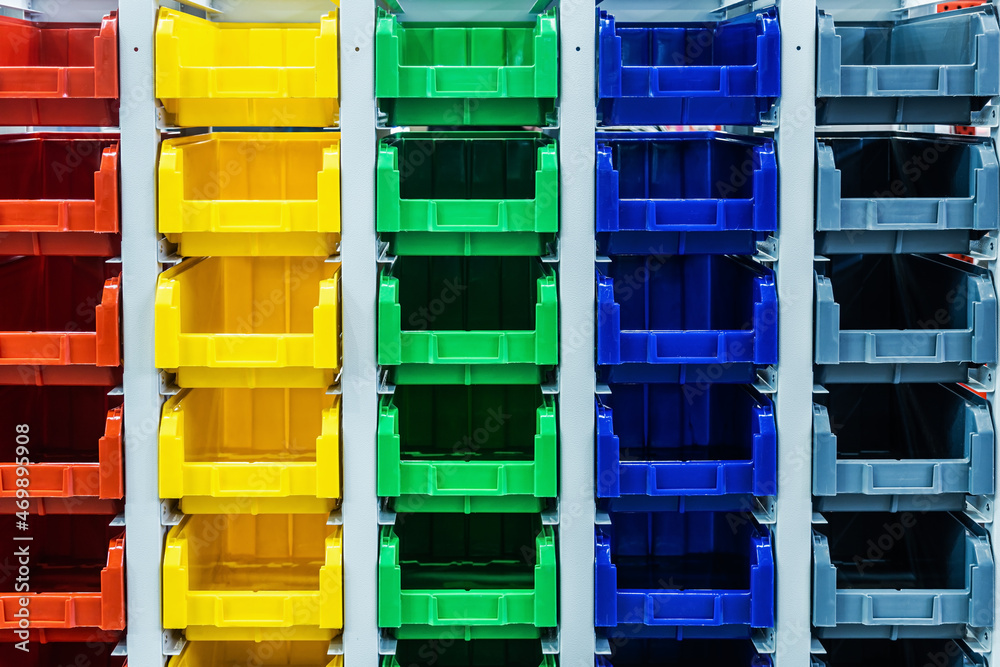 plastic boxes of different colors used in warehouses