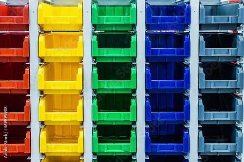 plastic boxes of different colors used in warehouses
