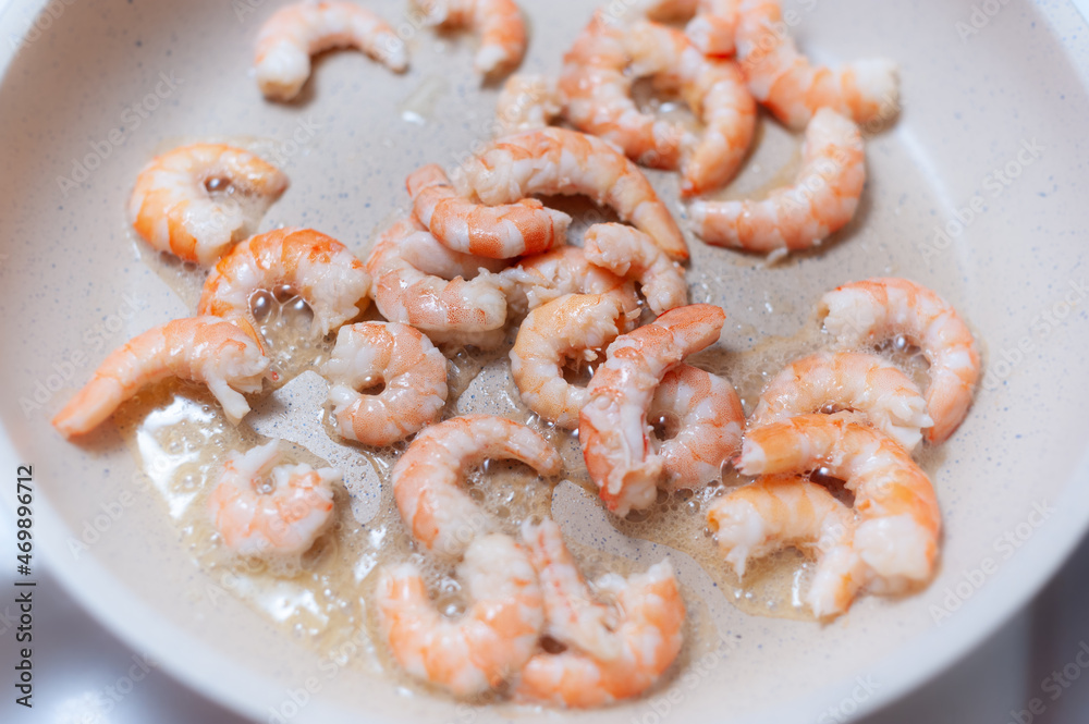 Shrimp fried in a white ceramic pan Shrimp fried in a white ceramic pan