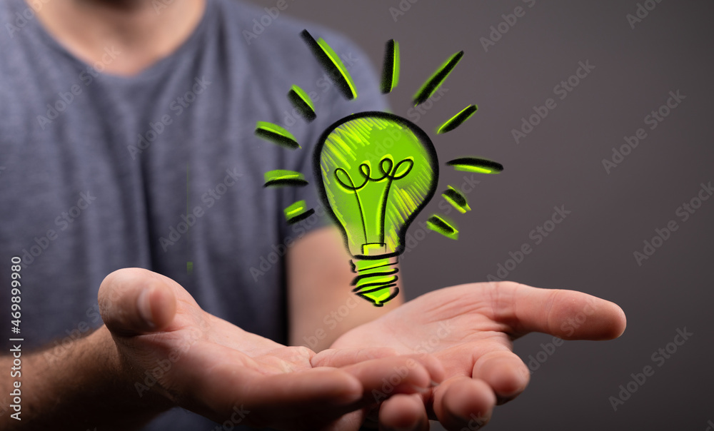 Hands holding green nature in the light bulb Hands holding green nature in the light bulb