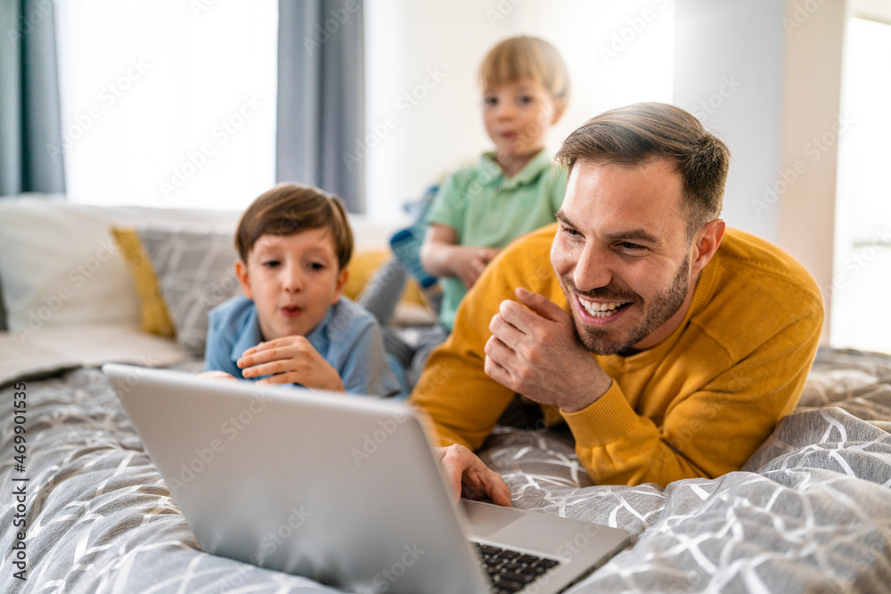 Happy family at home looking at laptop and having fun