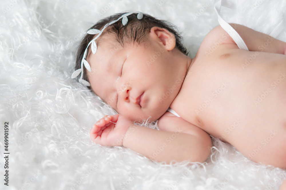 Newborn baby girl wearing angel wing. Newborn baby girl wearing angel wing.