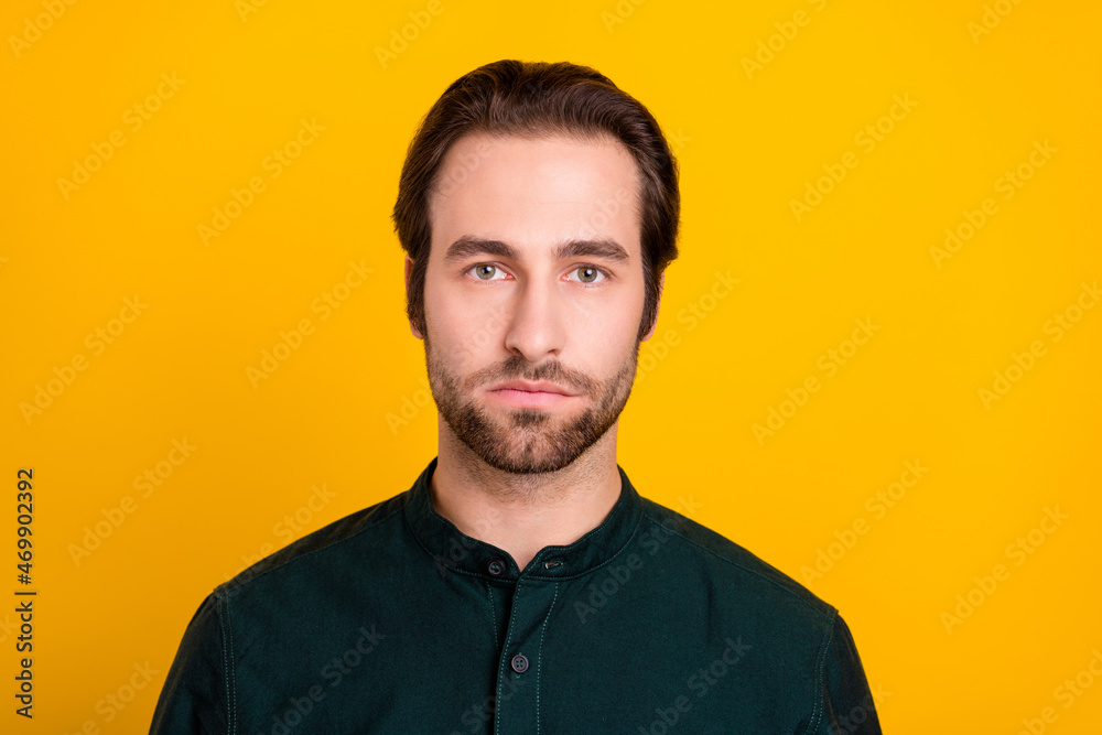 Photo of strict young bossy guy wear green shirt isolated on yellow color background