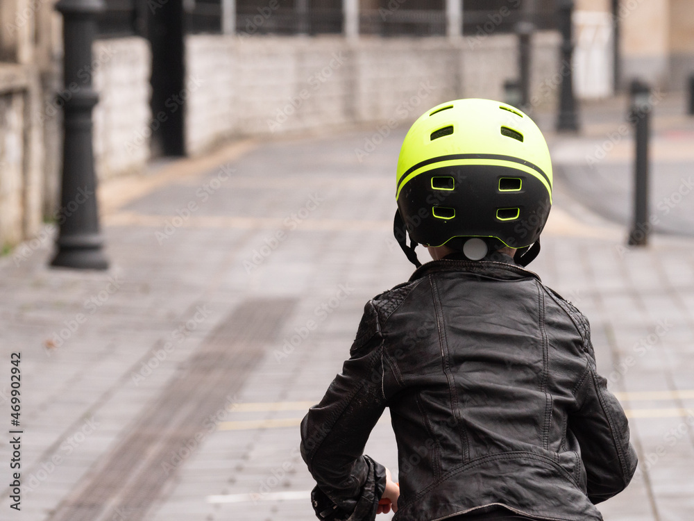 child on his back riding a bicycle scooter child on his back riding a bicycle scooter