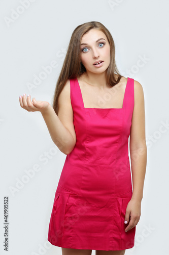Portrait of confused young woman complaining