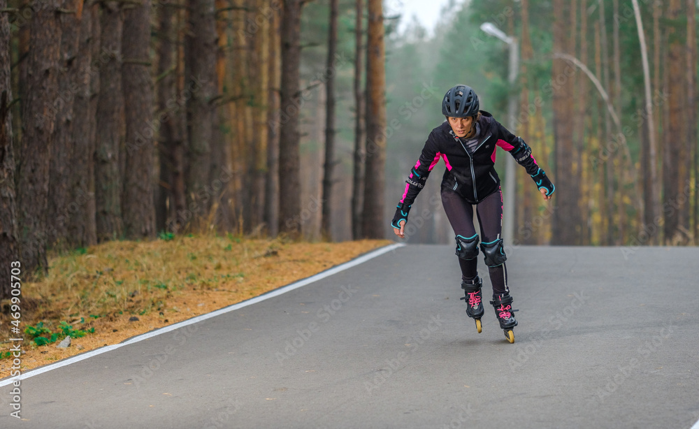 Roller skating sports girl in a helmet outdoors. Roller skating sports girl in a helmet outdoors.