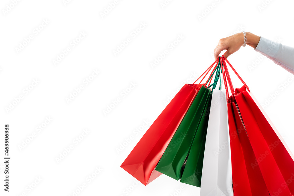 cropped view of female hand holding shopping bags isolated on white