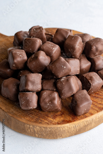 Chocolate covered Turkish delight on a white background. Traditional Turkish cuisine flavor. Story format