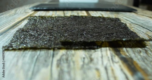 nori sheets fall on a wooden table photo