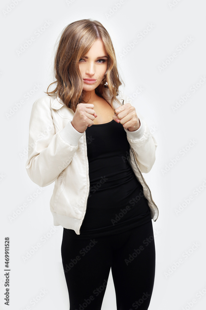 Portrait of angry teenage girl pointing power, woman tightens her fist