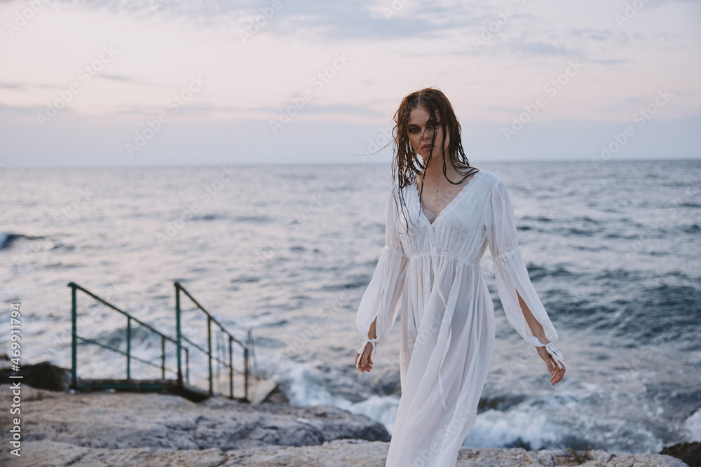 Attractive woman walks volcanic rock formations on the island nature Attractive woman walks volcanic rock formations on the island nature
