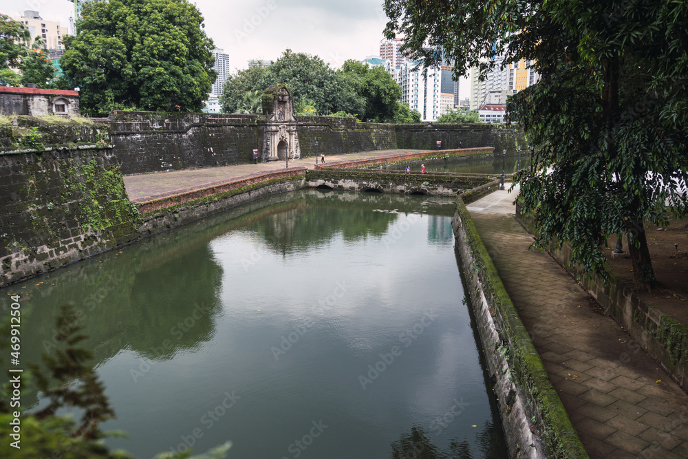 water channel before a fortress on a cloudy day. Fort Santiago. Moriones Square. Tourist.