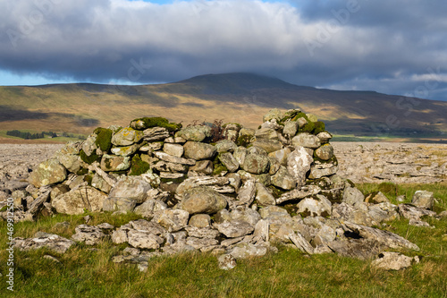 Tall cairn at Raven Scar below Ingleborough looking across the Twistleton Dale at Whenside photo