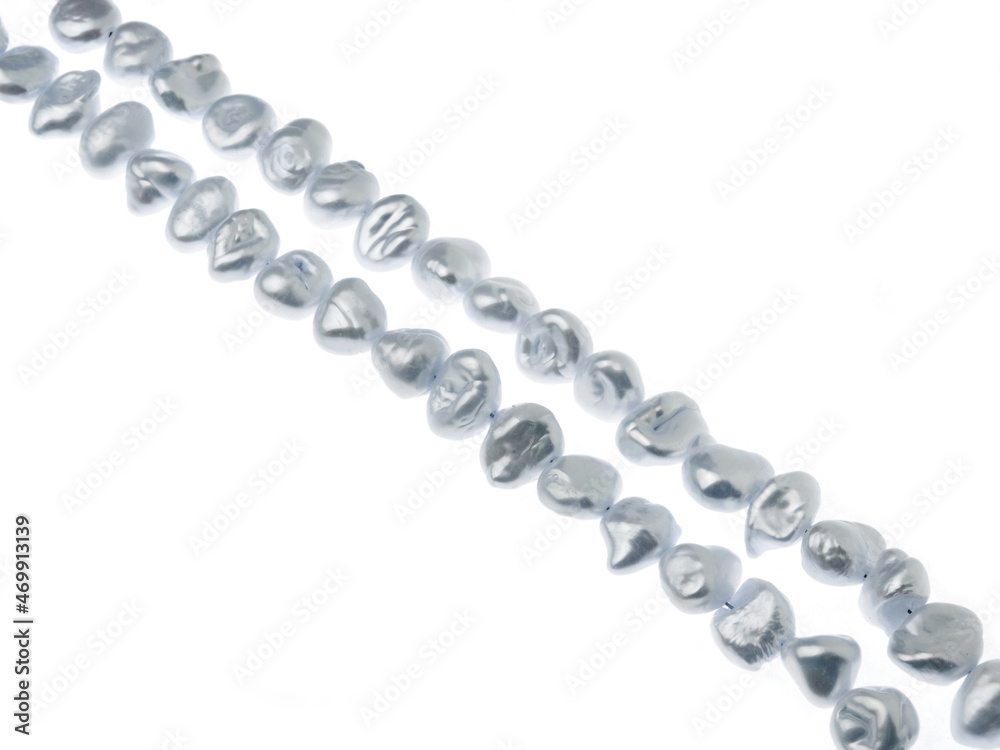 Two lines of gray baroque pearls isolated on white background Two lines of gray baroque pearls isolated on white background