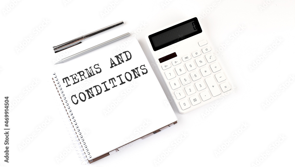 Notepad with text TERMS AND CONDITIONS with calculator and pen. White background. Business concept Notepad with text TERMS AND CONDITIONS with calculator and pen. White background. Business concept
