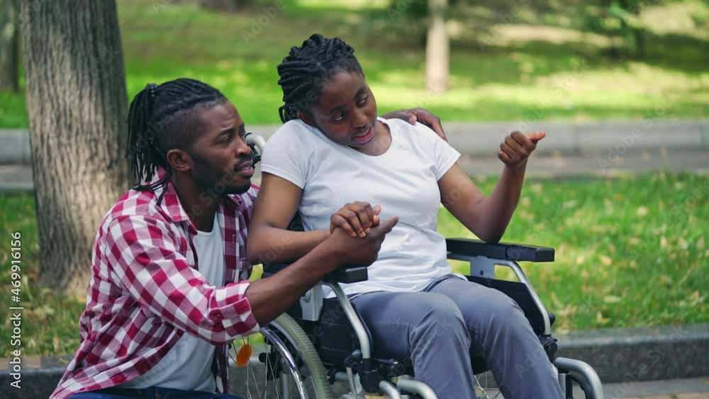custom made wallpaper toronto digitalCheerful young man holding woman in wheelchair by hand, friendly support