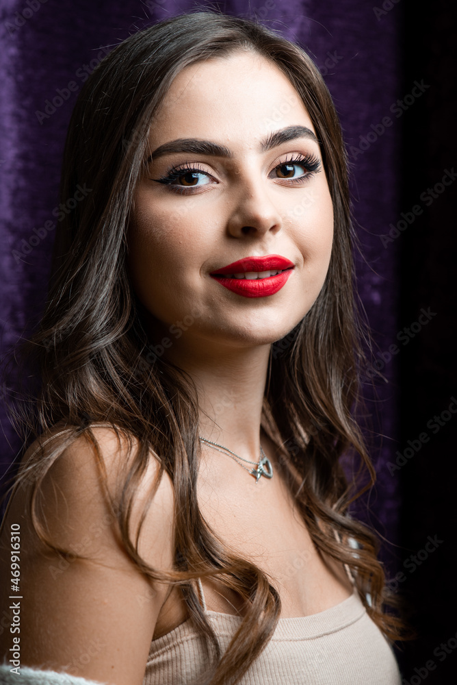 Beautiful young woman with make up and red lips