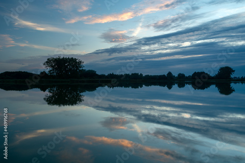 Fototapeta Naklejka Na Ścianę i Meble -  Evening clouds reflecting in the lake water, Stankow, Poland