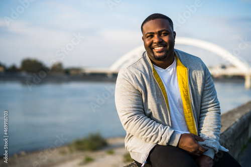 Happy black man enjoys  resting by the river. photo