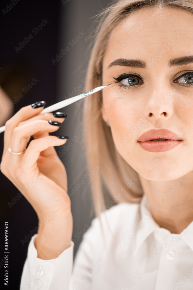 Make-up in a beauty salon for a young beautiful woman Make-up in a beauty salon for a young beautiful woman