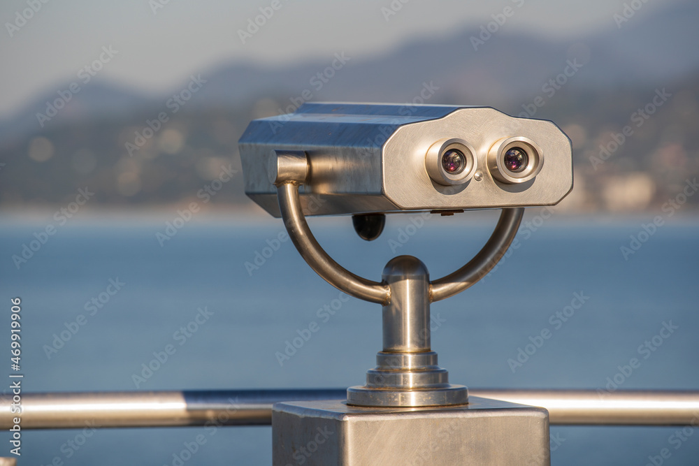 Public binocular on sea shore, close up