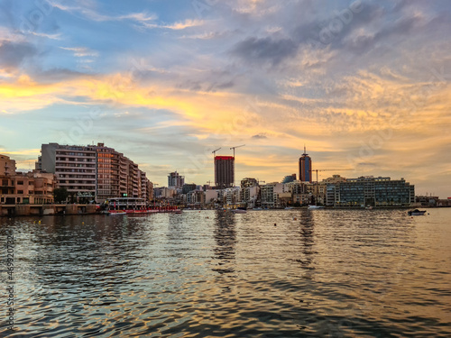 Golden clouds during sunset over Spinola Bay in Saint Julian’s Malta. photo