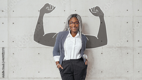 Valokuva business woman lean on wall with copyspace at right side and shows biceps