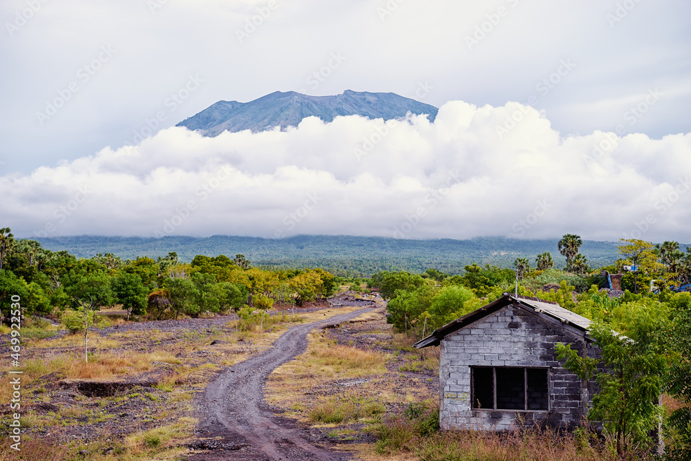 Beautiful landscape with top of Agung volcano at cloudy sky. Bali, Indonesia.
