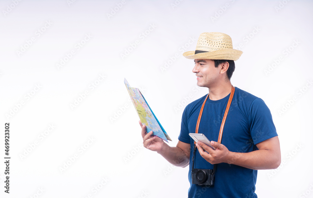 Lifestyle adventure leisure travel concept. Confident handsome traveler young man wear blue casual and hat with camera holding map and smartphone own hand while standing over isolated white background Lifestyle adventure leisure travel concept. Confident handsome traveler young man wear blue casual and hat with camera holding map and smartphone own hand while standing over isolated white background